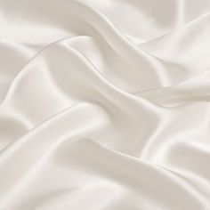 19mm silk satin fabric, 114cm wide, ivory white color. 100％ silk. How to care silk fabric: Washing: hand washing is advice 30 degrees, silk is a nature protein fiber so don't use harsh detergents that contain bleaches or brighteners, use only PH neutral detergent. Soaking silk for any more than afew minutes should be avoided. Drying: don't wring or twist, roll in towel to extract water. Avoid drying silk in direct sunlight. Any questions or comments on silk fabric, please let us know. Satin Wallpaper Silk Beige, Satin Fabric Images, Brilliant White Fabric, Luxury White Silk Evening Dress, Silk White Blanket, White Fabric For Dresses, Whitw Satin Wallpaper, Luxury White Satin Bodice, Cotton Silk Clothing Fabric