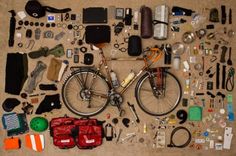 an assortment of items laid out on the floor to be used as a bike repair kit