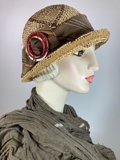 This light and airy women's straw hat is so pretty and practical. It is completely handmade, hand blocked and one of a kind. The hat is embellished with a fun vintage buckle and the band and bow are a pretty brown,burgundy and gold striped fabric. It is perfect for spring through fall. Her name is Christie. A great ladies hat that stands apart from mass produced ones. Pair it with a flowing dress or even with shorts and a fun tee. Adjustable Inner grosgrain ribbon headband fits 21 to 22 1/2 inch head size. In stock and ready to ship. +++++++++++++++++++++++++++++FIT AND SIZE:Adjustable inner band - Fits a 21 inch - 22 1/2 inch head size. ++++++++++++++++++++++++++++++SHIPPING:Free shipping in the contiguous US via USPS. +++++++++++++++++++++++++++++++CUSTOM ORDERS:I am happy to make a hat Spring Woven Straw Cloche Hat, Beige Cloche Hat For Vacation, One Size, Brown Wide-brim Cloche Hat For Vacation, Summer Beach Cloche Hat, One Size, 1930s Straw Hat, Straw Cloche Hat, Burgundy Hat, Womens Straw Hats, Flapper Hat