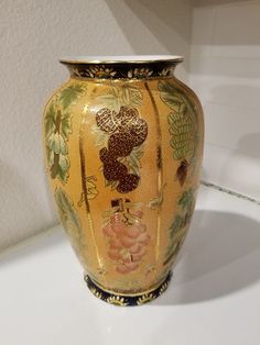 a yellow vase sitting on top of a white counter next to a wall and floor