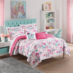 a bed room with a neatly made bed and pink curtains