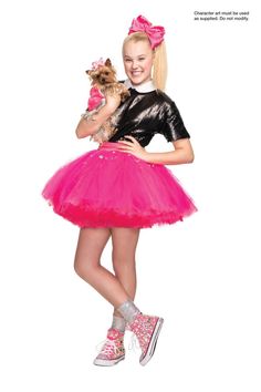 a girl in a pink tutu holding a small dog