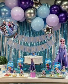 a frozen princess birthday party with balloons, cake and decorations