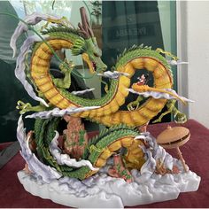 a dragon statue sitting on top of a table