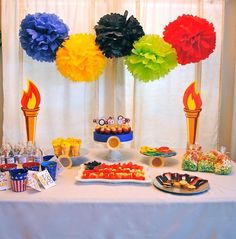 a table topped with lots of desserts and cupcakes on top of it