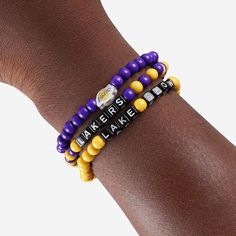 A whole new way to rep the team in style is here. Step up your fan fashion sense with this Los Angeles Lakers 3 Pack Beaded Friendship Bracelet. These matching friendship bracelets have an all-over team-colored design and team logo displays, which makes them the perfect way to show your support for the Los Angeles Lakers on gamedays and every day in between. Every bead bracelet design is the perfect addition to your outfit, whether you’re heading to the game, watching at home, or just hanging ou Casual Personalized Beaded Bracelets For Fans, Casual Game Day Wristband With Letter Beads, Casual Team-colored Beaded Bracelets For Sports Events, Casual Beaded Bracelets In Team Colors For Sports Events, Casual Multicolor Bracelets For Game Day, Matching Friendship Bracelets, Lakers Colors, Cool Friendship Bracelets, Calendar Reminder