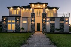 a large house with lights on the windows