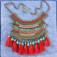 Gorgeous tassel necklace. Well made bronze tone chain and colorful glass beads (faux turquoise and faux coral) tribal bib necklace. Red tassels. Velvet backing. Necklace is adjustable from approx 12 to 14 1/2 inches. Condition is very good vintage. As found. I leave decision of cleaning up to buyer. Turquoise Tassel Necklaces For Festivals, Bohemian Turquoise Bib Necklace With Colorful Beads, Red Beaded Bohemian Bib Necklaces, Bohemian Tassel Necklace With Beaded Chain, Red Bohemian Bib Necklace For Festivals, Bohemian Turquoise Necklaces With Tassels, Bohemian Tassel Necklace With Dangling Beads For Beach, Bohemian Gold Necklace With Beaded Fringe, Handmade Turquoise Tassel Necklace Bohemian Style