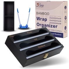 the bamboo wrap organizer is next to two blue toothbrushes and a cardboard box