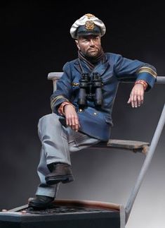 a figurine of a man in uniform sitting on a chair with a telescope