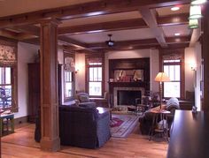 a living room filled with furniture and a fire place in the middle of a room