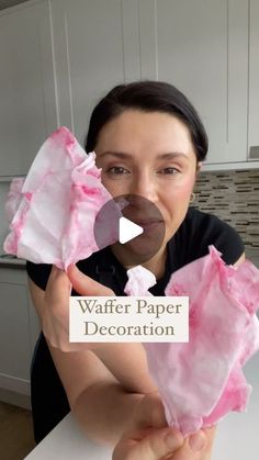 a woman holding up pink tissue paper in front of her face with the words waffle paper decoration on it