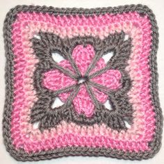 a crocheted square with a flower on it