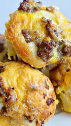 three muffins stacked on top of each other with cheese and meat in them