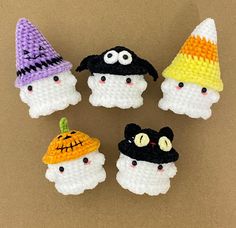 four small crocheted halloween decorations on a table