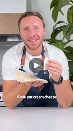 a man in an apron is holding some food