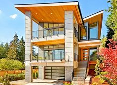 a two story house with lots of windows and balconies on the second floor