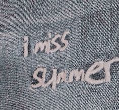 the word i miss you written on an old pair of jeans