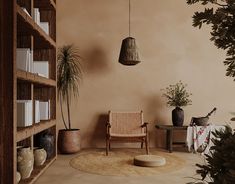 a living room filled with lots of furniture and potted plants next to a book shelf