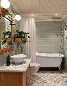 a bath room with a toilet a tub and a sink