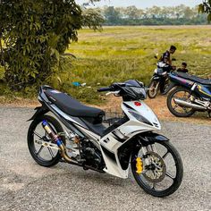 two motorcycles parked next to each other on a road