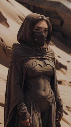 a woman in a costume standing on sand dunes