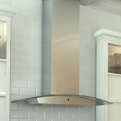 a stove top oven sitting inside of a kitchen next to a wall mounted range hood