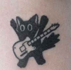 a black and white photo of a cat with a guitar tattoo on it's leg