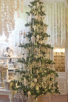 a decorated christmas tree in front of a window