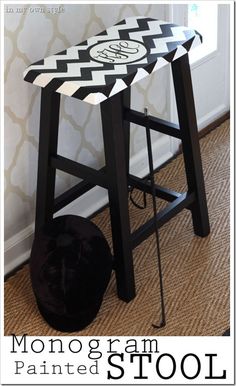 a black and white stool sitting next to a window