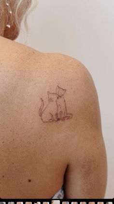 a woman with a cat tattoo on her back