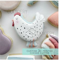 some cookies are laying on top of each other and decorated with icing to look like chickens