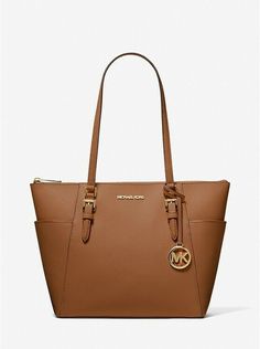 NEW WITH TAGS Authentic Michael Kors Charlotte Large Top Zip Tote Luggage (Tan/Brown) • Saffiano leather • Gold-tone hardware • 15”W X 10”H X 4.75”D • Handle drop: 10” • Exterior details: 2 side slip pockets • Interior details: back zip pocket, 2 front slip pockets • Lining: 100% polyester • Zipper fastening Style 35TOGCFT7 Michael Kors Tote Bags, Michael Kors Shoulder Bag, Mk Bags, Work Tote, Zip Tote, Leather Luggage, Purses Michael Kors, Daily Essentials, Shoulder Tote Bag