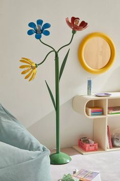 a living room with a couch, table and flowers on the wall