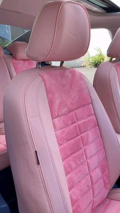 the interior of a car with pink leather seats