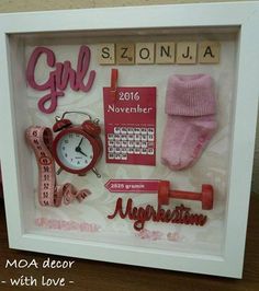 a shadow box frame with pink items in it and the word girl written on it