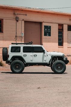 a white jeep parked in front of a building