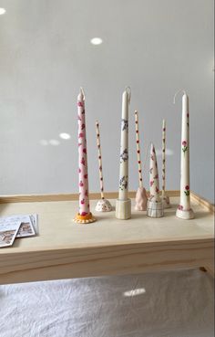 five candles are lined up on a table