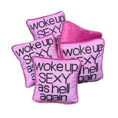 three pink pillows with words on them