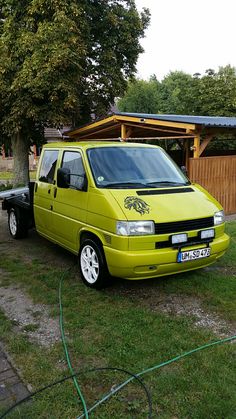 a yellow van is parked in the grass