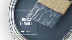 a paint can with the words english channel painted on it and a brush in front of it