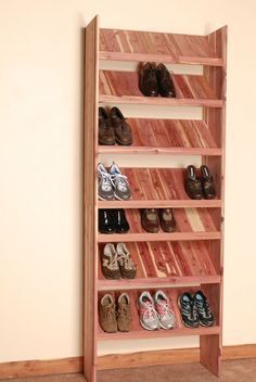 a wooden shoe rack filled with pairs of shoes