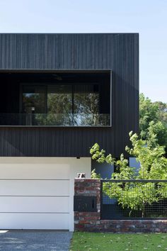 a black and white house with two garages