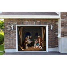 the nativity scene is displayed in an open garage door