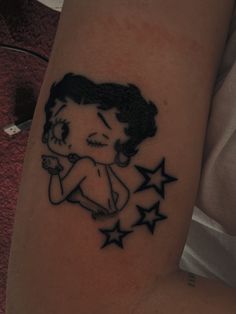 a woman's tattoo with stars on her arm