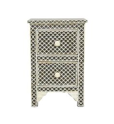 a white and black cabinet with two drawers on one side, and an intricate design on the other