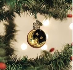 an ornament hanging from a christmas tree with lights in the background and stars on it