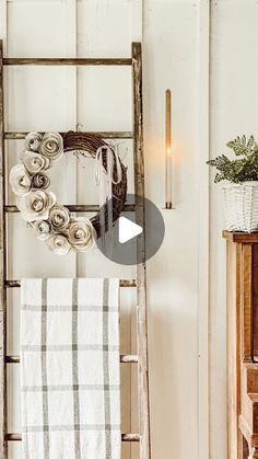 an old ladder is used as a towel rack