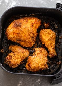 some chicken is cooking in a pan on the table