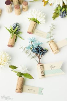 wine corks with flowers and place cards on them